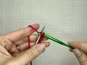 Using your crochet hook, chain 1, by pulling the yarn through the loop on your hook. There should be one loop on your needle and one loop on your hook.