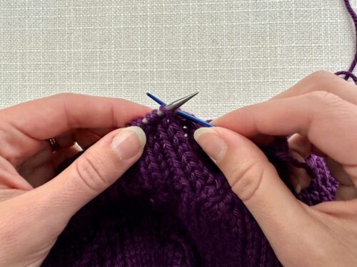First, insert your tapestry needle knitwise into the first knit stitch and slide the stitch off your knitting needle onto your tapestry needle.