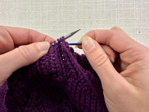 Insert your tapestry needle into the second purl stitch knitwise. Pull your yarn through, keeping your yarn behind your needles.