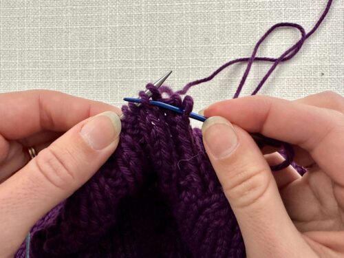 Keep the tapestry needle in front of your work, insert the tapestry needle purlwise into the next knit stitch. Pull your yarn through, keeping it in front of your work.