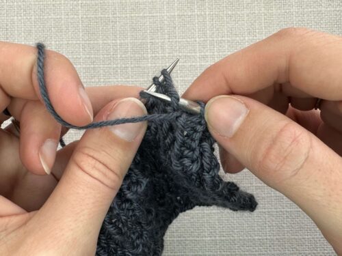 Pb1 in Knitting Step 1. Insert your right-hand needle from the back to the front of your knitting into the center of the stitch below your left-hand needle.