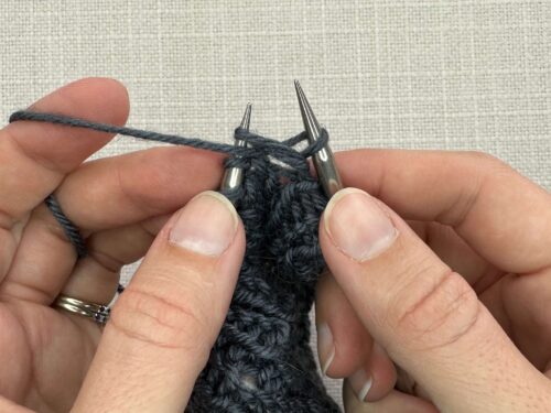 Pb1 in Knitting Step 3. Pull the yarn back through the stitch taking care to come back under the purl bump and not through the working stitch.
