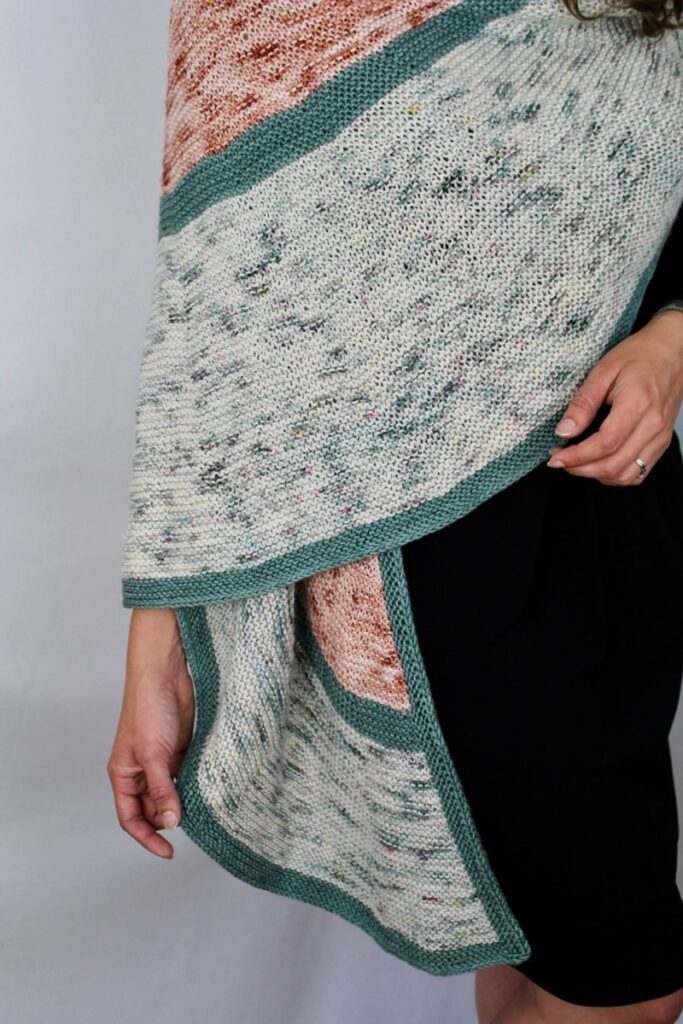 Close-up of the peach Highlight, pale speckled Pedestal, and teal framing in the One Cloudy Night shawl.